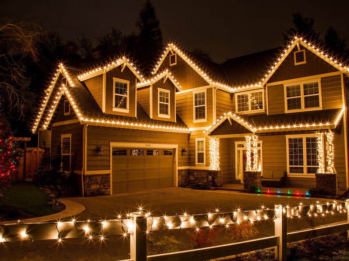 Two-story home with C9 lights tracing every peak and gable