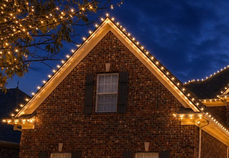 Classic C9 bulbs tracing a brick gable roofline
